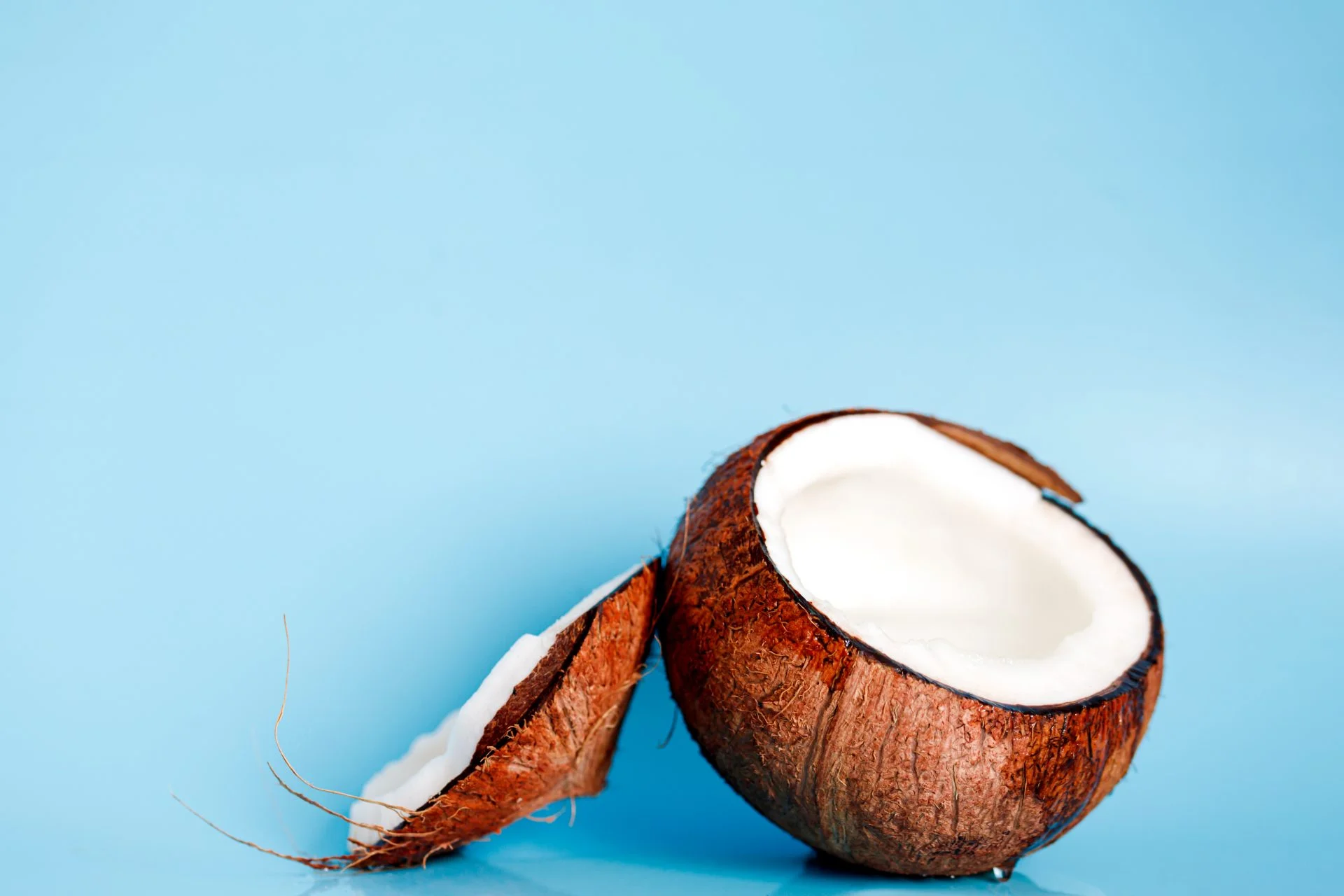 background with split coconuts close-up. coconuts and copy space