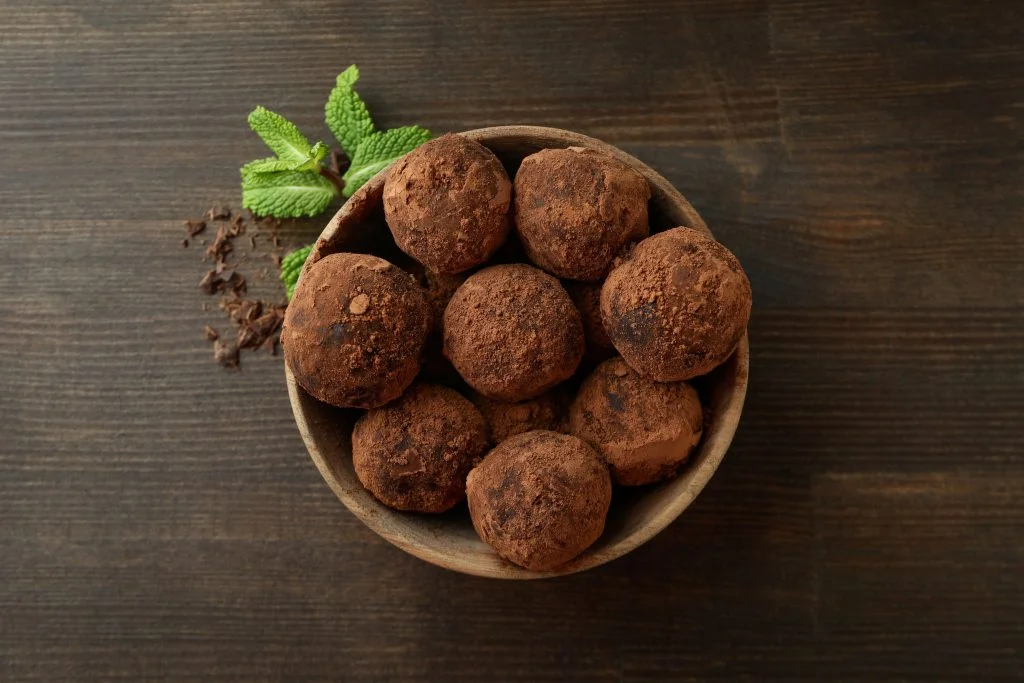Concept of sweets with truffles on dark wooden background