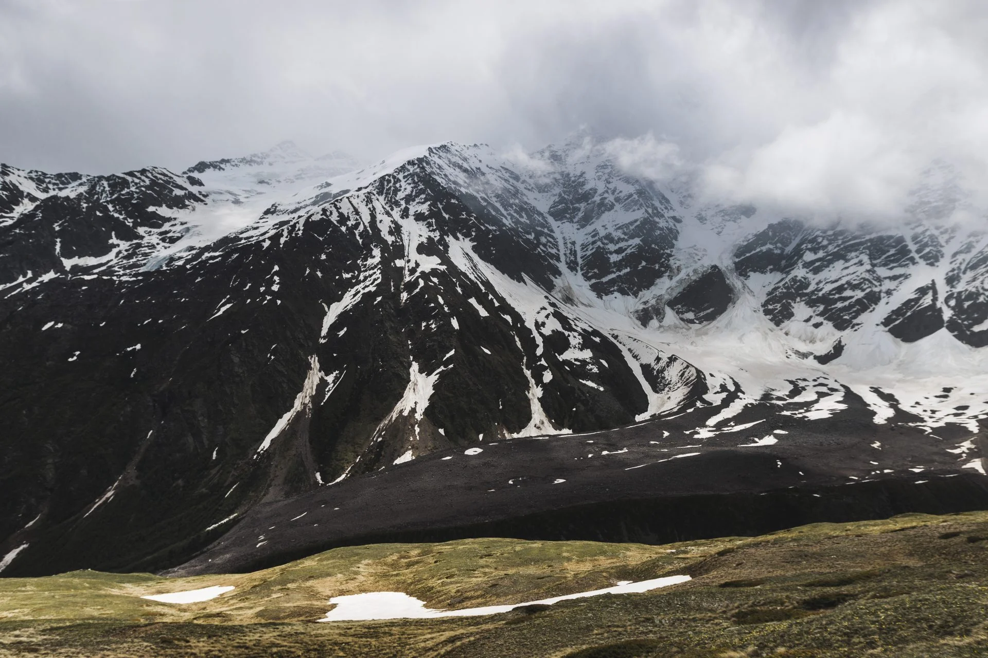 Panoramic view of high mountain peaks in snowy and foggy cold we