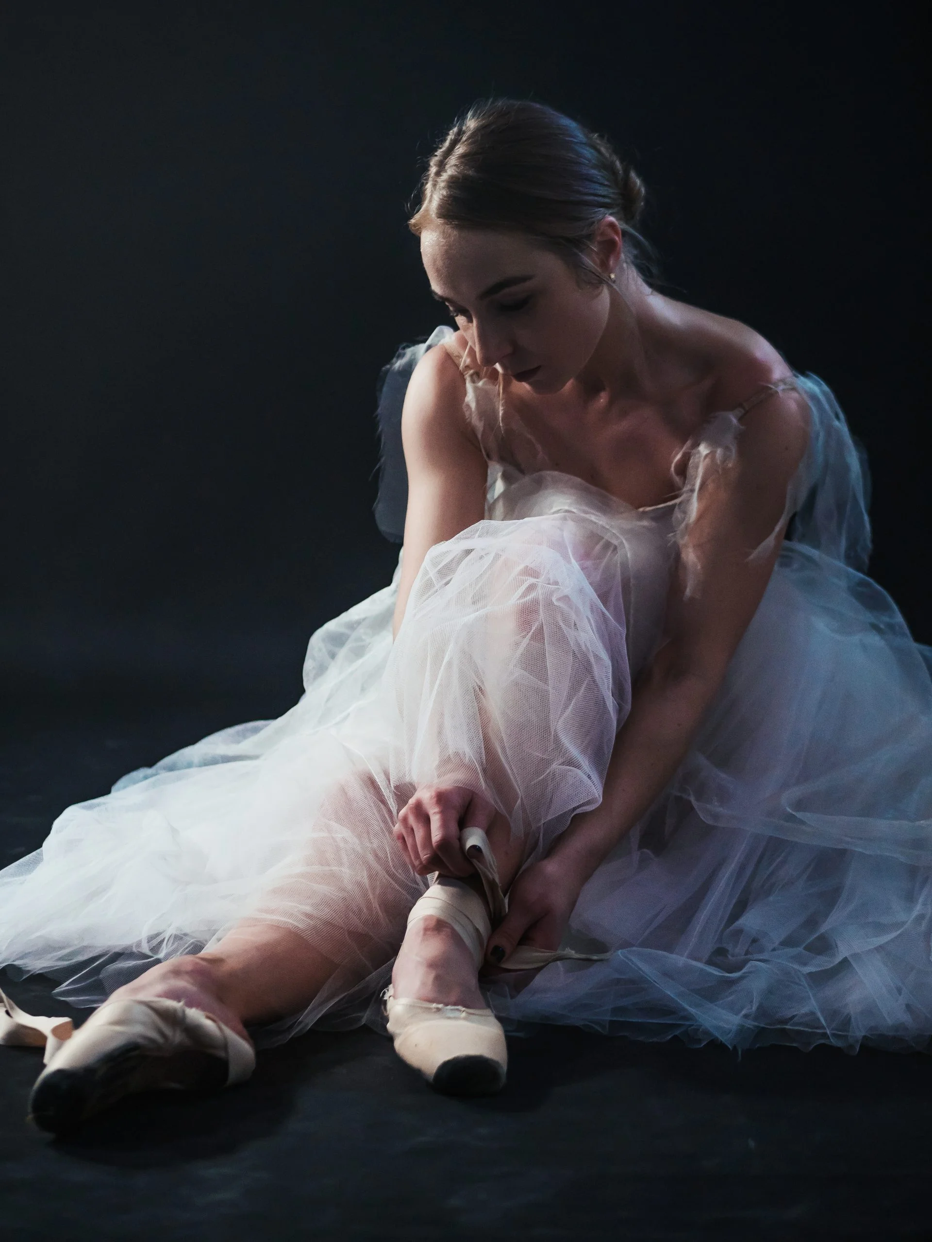 woman-corrects-her-pointe-shoes-2021-08-29-02-32-44-utc