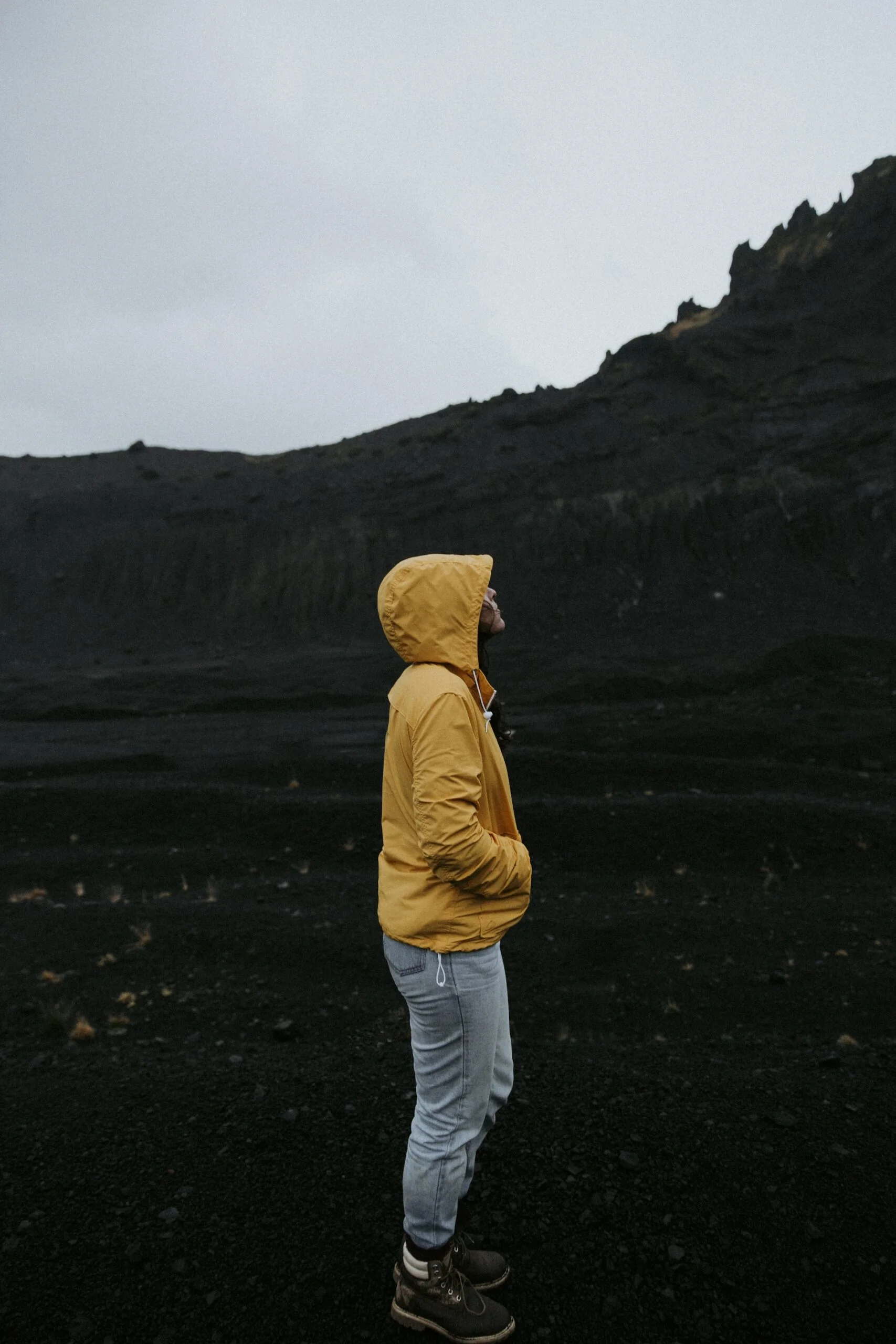 Person standing beside mountain
