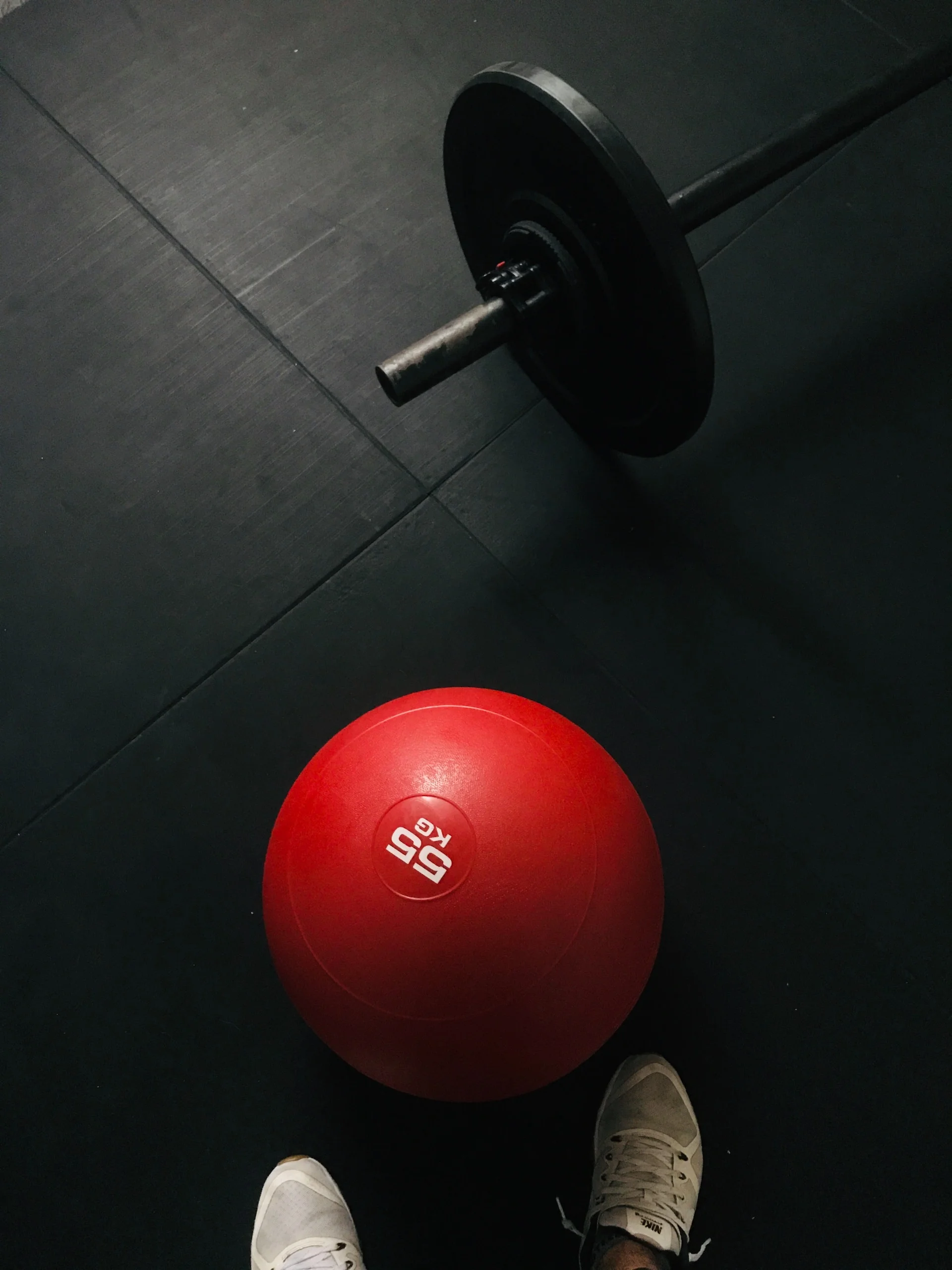 Red and black dumbbell on black floor